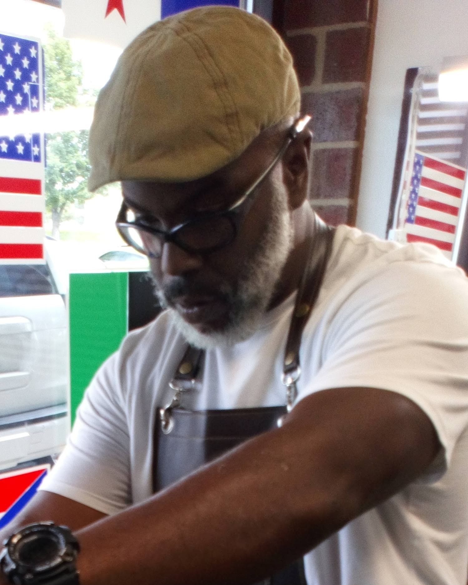 Hanif Akins in his apron at Nisusthebarberman in Colorado Springs